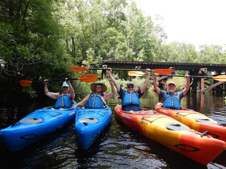 four people in rental kayaks