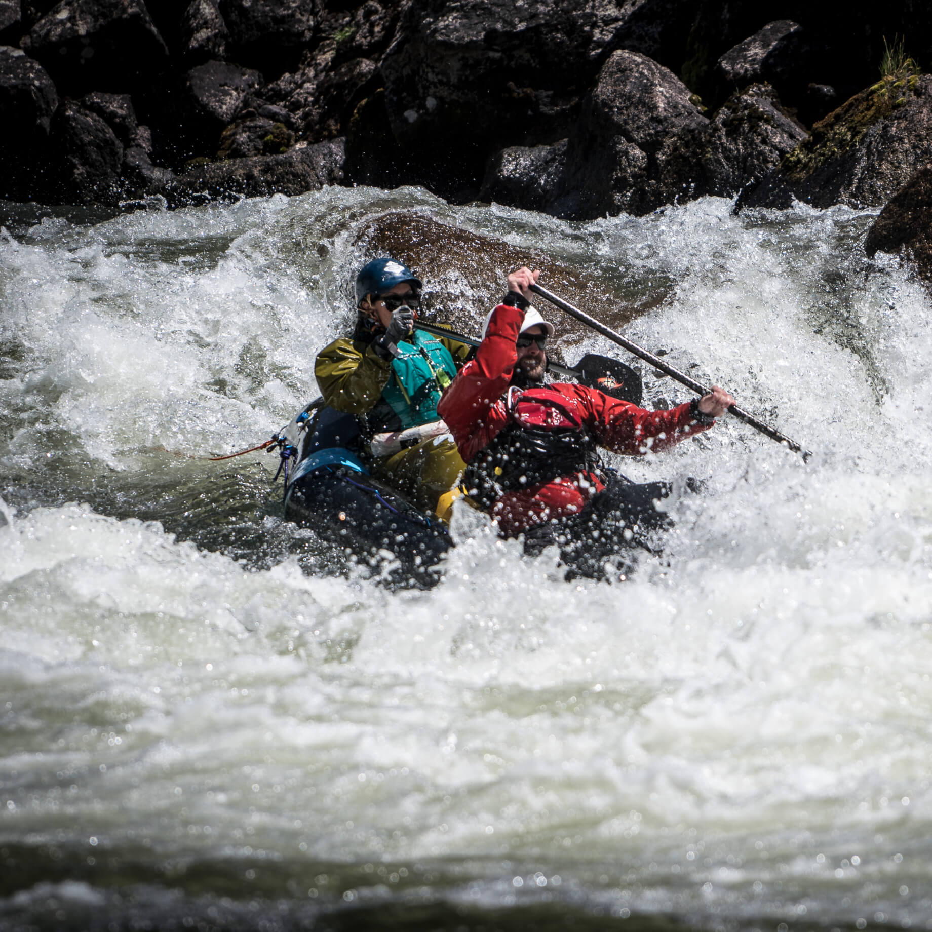 two people packrafting rapids