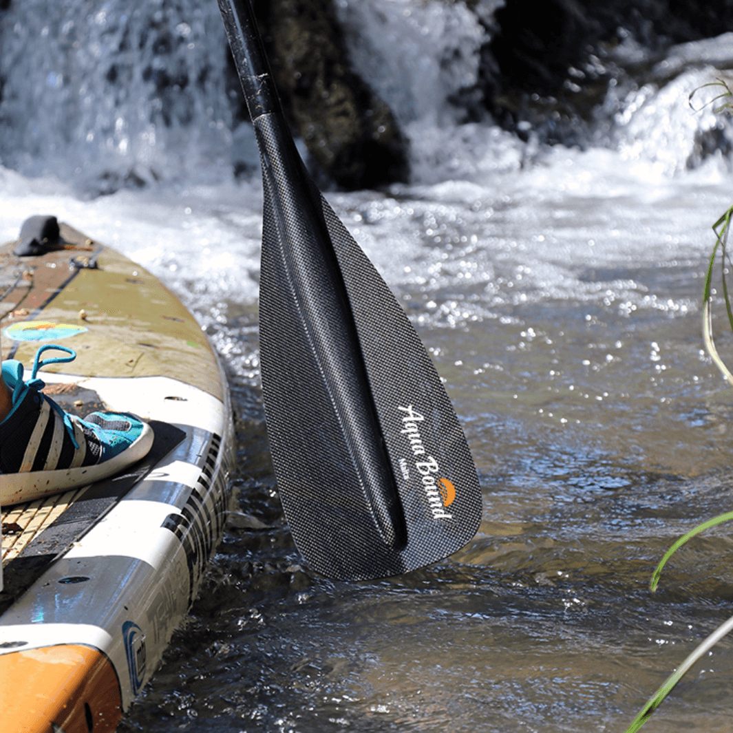 Malta carbon 1-piece SUP paddle blade with waterfall behind it