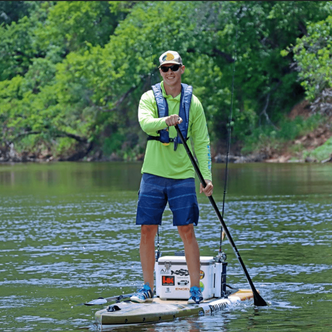 boy paddling toward the camera on paddle board with a lime green shirt and the Malta carbon 2-piece SUP paddle