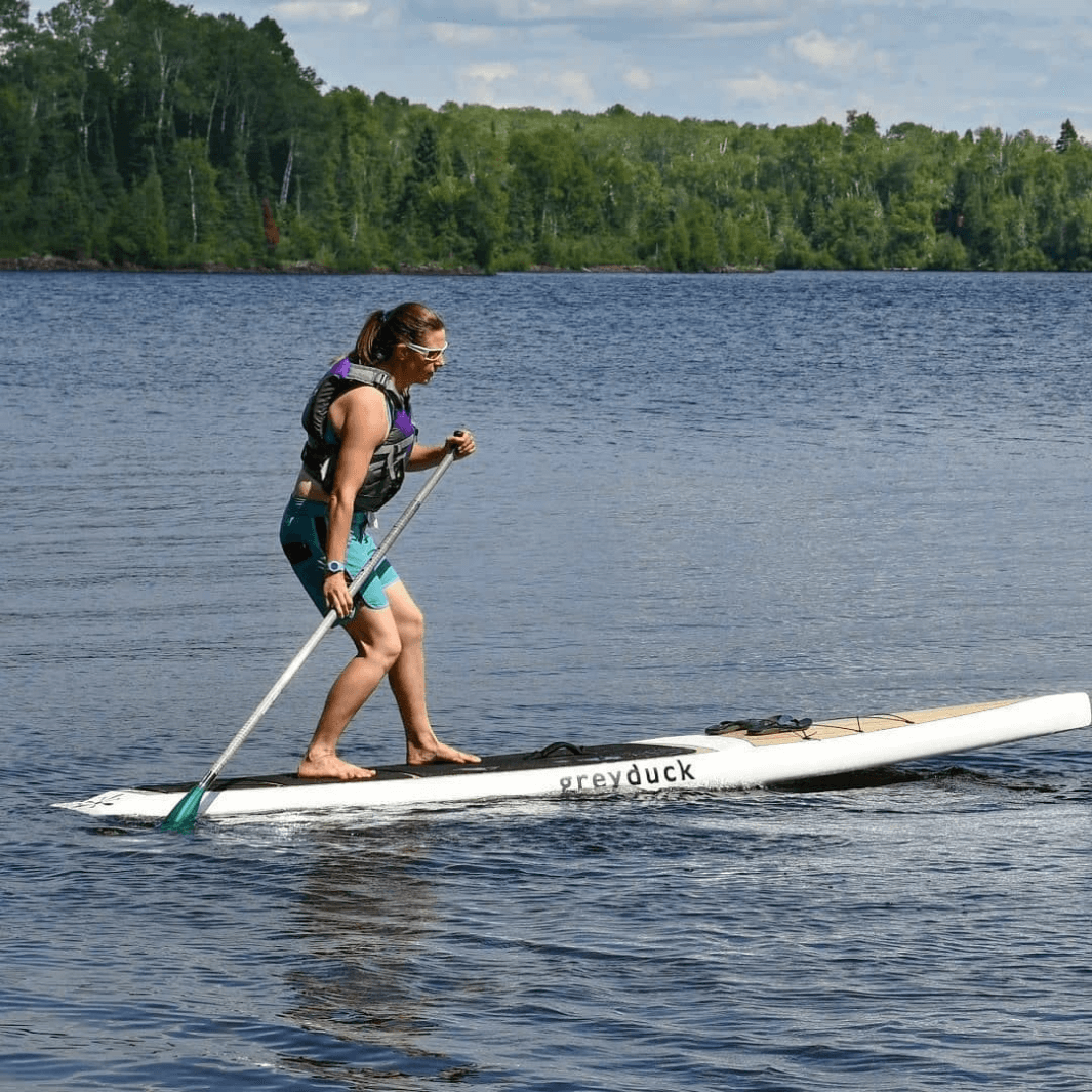 Woman using Malta green tide SUP paddle showing off cool trick on SUP board#color_green-tide