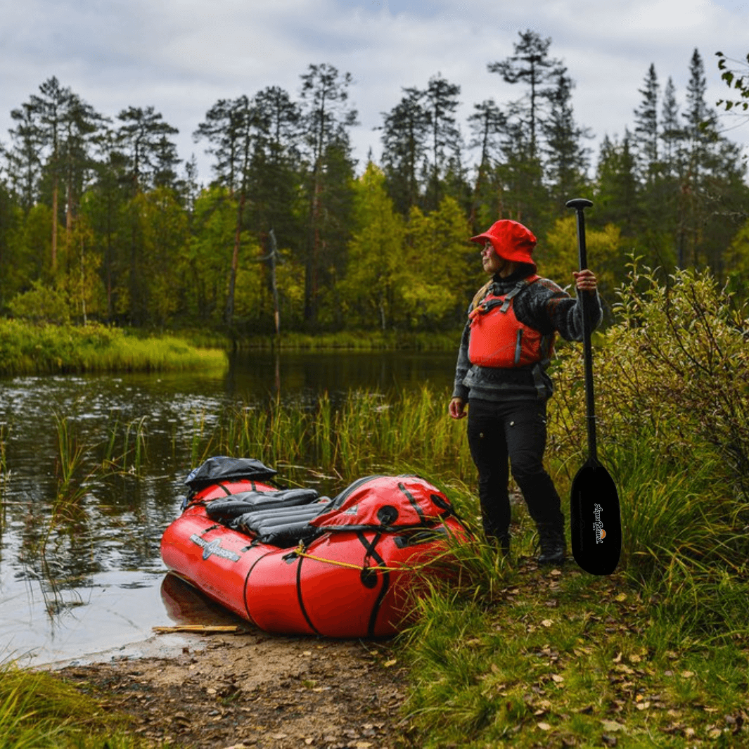 Ambassador Katjia holding one canoe paddle from the shred apart before heading out in her Oryx packraft