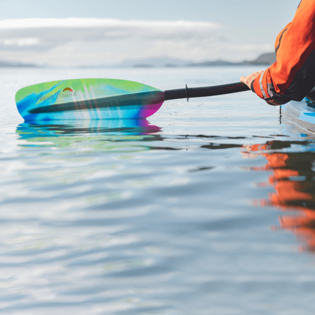 tango fiberglass bent shaft kayak paddle northern lights blade half way in water #color_northern-lights