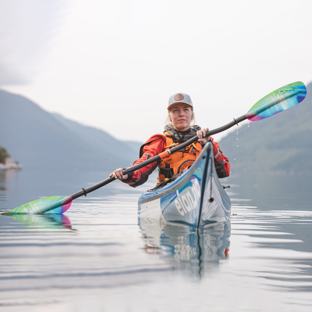tango fiberglass bent shaft kayak paddle northern lights being paddled towards camera in Norway #color_northern-lights