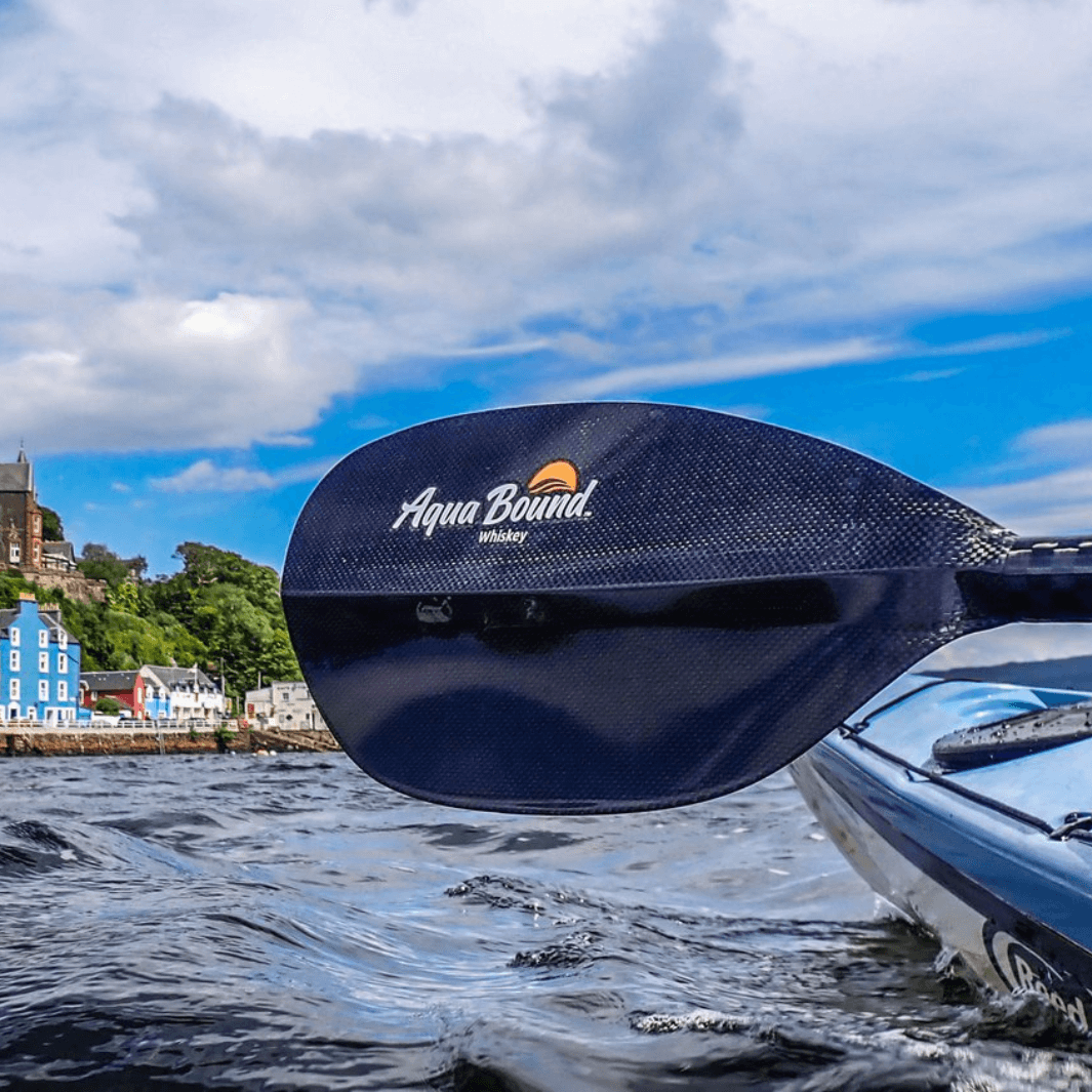 whiskey carbon 2-piece kayak paddle close up of blade by kayak