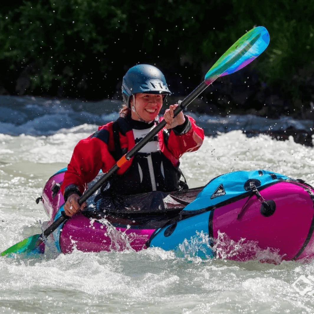 woman packrafter with whiskey northern lights through rapids#color_northern-lights